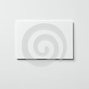 A blank, white card on a light grey, textured surface. The card has a smooth texture,