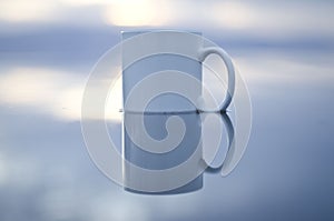 Blank white coffee mug on water