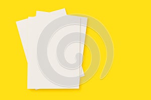 Blank white cover magazines stack mockup on yellow background