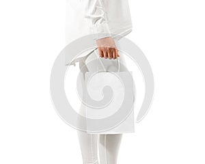 Blank white craft paper bag mockup holding hand, clipping path.