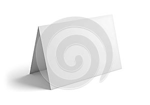 Blank white folded card standing on a white surface ready for custom design