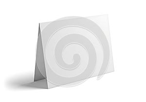 Blank white folded card standing upright on a white surface with subtle shadow
