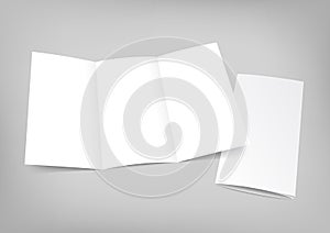 Blank white folding paper flyer on gray background photo