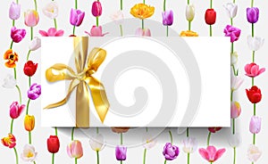 Blank white gift card with gold ribbon on floral background tulip flowers in vertical lines