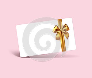 Blank white gift card with realistic gold ribbon bow