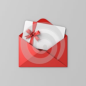 Blank white gift card with red ribbon bow or gift voucher in open red envelope on white grey background with shadow