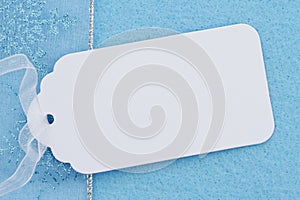 Blank white gift tag on blue felt