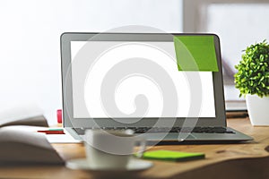 Blank white laptop with green sticker