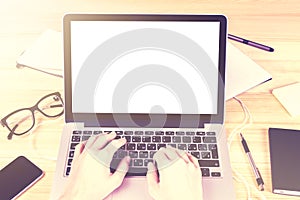 Blank white laptop screen with girl hands and office accessories