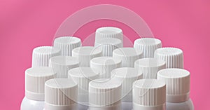 Blank white lids of spray cans for branding mock-up on pink background.