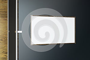 Blank white mock up banner on dark wall. Advertisement and office concept.