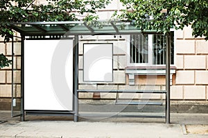 Blank white mock up of bus stop vertical billboard in front of empty street background