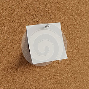 A blank white note is pinned to a corkboard with a silver thumbtack. The corkboard