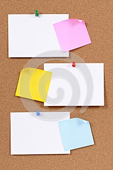 Blank white office index cards with post it style sticky notes on cork board, copy space