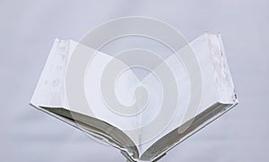 Blank white open book on a uniform backgroundblank white open book