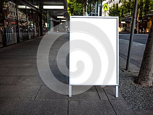 Blank white outdoor advertising stand/sandwich board mock up template. photo