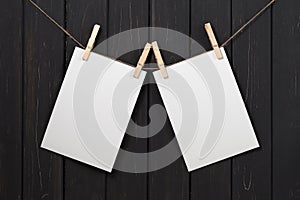 Blank white paper cards hanging on clothespins