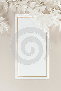 Blank white paper mockup and beige branches