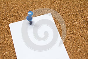 Blank white paper pin on cork board background