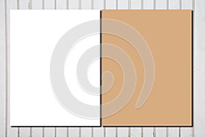 Blank white paper sheets and brown envelope for brochure on wooden grey background in top view empty Mock up