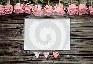 Blank white paper with three hearts and roses