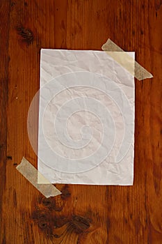 Blank white paper on wood grain surface