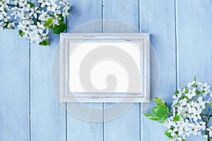 Blank White Picture Frame over Light Blue Spring Background