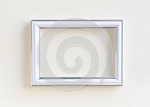 Blank white picture frame on a plain beige background.