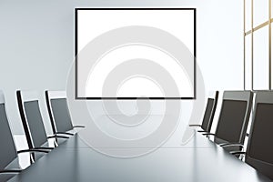 Blank white picture frame on the wall of conference room