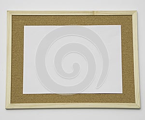 Blank white piece of letter sized paper on a cork notice board