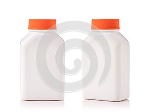 Blank white plastic bottle with red cap. Studio shot isolated on white