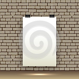 Blank white poster hanging on brick wall.