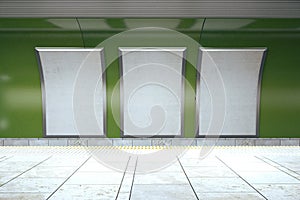 Blank white posters on green subway wall