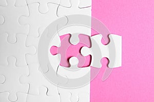 Blank white puzzle with separated piece on background, flat lay