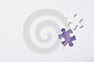 Blank white puzzle with separated piece on purple background. Space for text