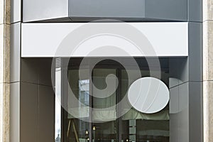 Blank white rectangular and round sign on business center mockup photo