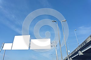 Blank white road sign on highway, empty traffic sign blue sky background