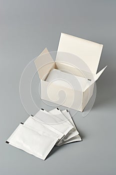 Blank white sachet packets with a box isolated
