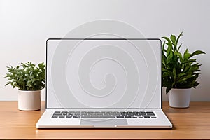 Blank white screen with laptop computer mockup isolated on office desk background