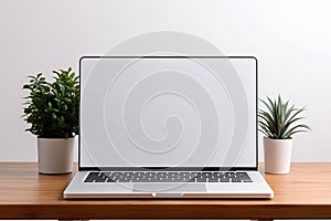 Blank white screen with laptop computer mockup isolated on office desk background