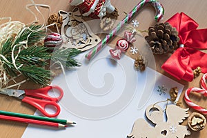 Blank white sheet of paper surrounded with festive christmas decorations. Merry Christmas and Happy New Year. Xmas