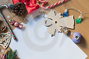 Blank white sheet of paper surrounded with festive christmas decorations. Merry Christmas and Happy New Year. Xmas concept. Top