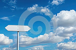 Blank white signpost against blue sky with clouds photo