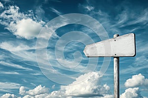 Blank white signpost against blue sky with clouds photo