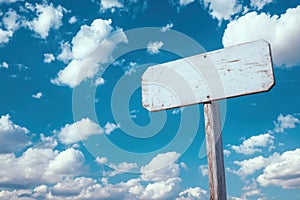 Blank white signpost against blue sky with clouds photo