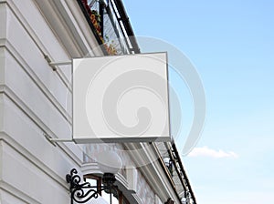 Blank white square sign on wall mock up, sky background