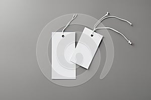 blank white tag on white background blank white paper tag with a string on a gray backgroundblank white tag on white background