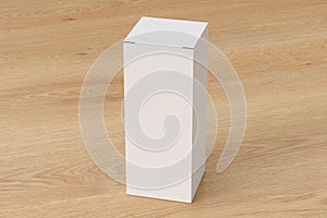 Blank white tall and slim gift box with closed hinged flap lid on wooden background. Clipping path around box mock up.