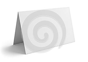 Blank white tent card standing on a white surface with shadow