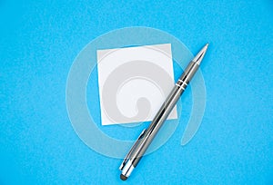 Blank white To Do List Sticker with pen. Searching information on the Internet..Close up of reminder note paper on the blue